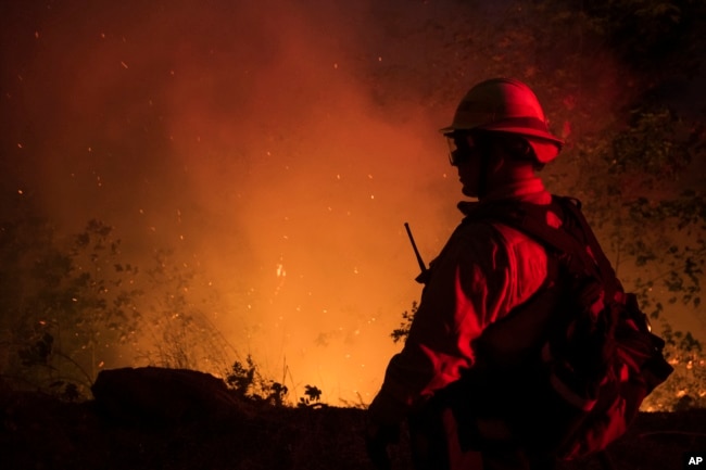 A firefighter from the city of Monterey monitors flareups from the Park Fire near Butte Meadows, Calif., Sunday, July 28, 2024. (AP Photo/Nic Coury)