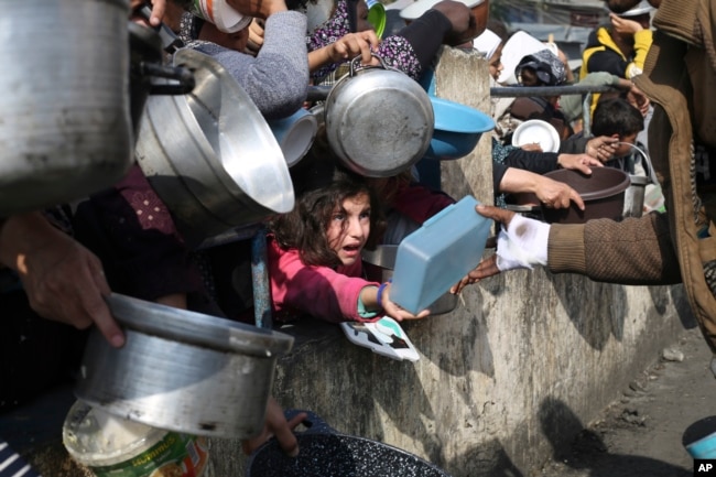 Palestinians line up for free food during the ongoing Israeli air and ground offensive on the Gaza Strip in Rafah, Jan. 9, 2024.