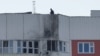 A man inspects damage atop a multi-story apartment block following a reported drone attack in Moscow, May 30, 2023.