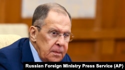 FILE — Russian Foreign Minister Sergey Lavrov talks with Chinese Foreign Minister Wang Yi in Beijing, China, Oct. 16, 2023. The foreign ministers of the three Baltic states and Ukraine pledge to boycott this week's OSCE meeting in North Macedonia to object Lavrov's participation.
