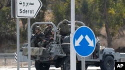 Israeli soldiers head south near Ashkelon, Israel, on Oct. 7, 2023.