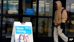 FILE - Hiring signs are displayed at a retail store in Downers Grove, Illinois, May 1, 2023. 
