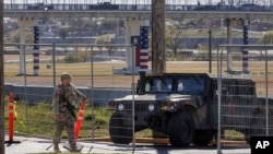 Texas Department of Public Safety officers guard an entrance to Shelby Park on Jan. 11, 2024, in Eagle Pass, Texas.