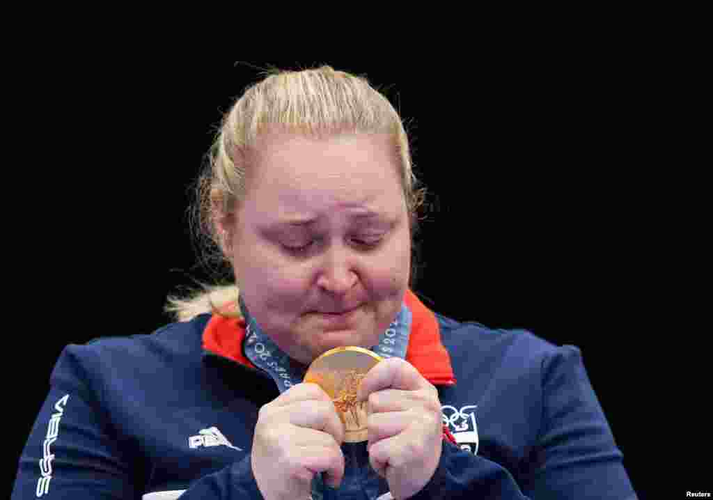 Gold medallist Zorana Arunovic of Serbia looks at her medal after winng the 10m air pistol mixed team even at the Paris Olympics in Chateauroux, France, July 30, 2024.