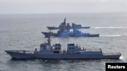 FILE - A South Korean Navy destroyer Yulgok Yi I, the US Navys destroyer USS Benfold and Japan Self-Defense Force's destroyer Atago take part in joint naval missile defense exercises in international waters between Korea and Japan, April 17, 2023.