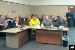 FILE - In this image taken from El Paso County District Court video, Anderson Lee Aldrich, then 22, center, sits during a court appearance in Colorado Springs, Colorado, Nov. 6, 2022.