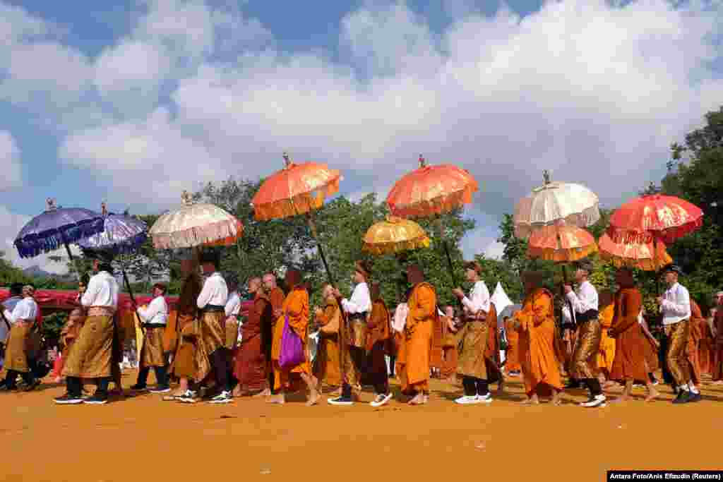 Будистичките монаси шетаат во комплексот на храмот Боробудур за време на прославата на денот Весак во Магеланг, Индонезија.