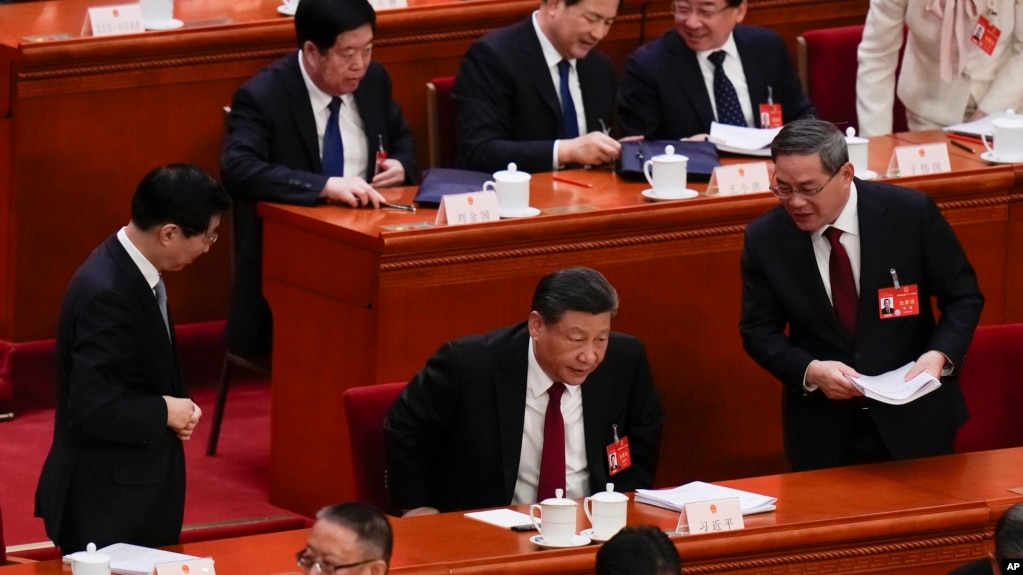 中国领导人习近平、总理李强和全国政协主席王沪宁在人大会堂进行的全国人大会议上。（2024年3月5日）