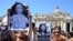 People hold placards with Emanuela Orlandi's portrait at the end of Pope's Angelus prayer in St. Peter's Square at the Vatican, June 25, 2023.