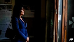 Carla Segovia, a transgender woman from Argentina, walks out of the Beata Vergine Immacolata parish church in Torvaianica, Italy, Nov. 16, 2023.