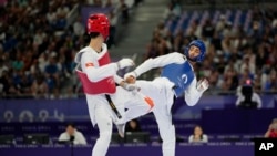 Hong Kong's Lo Wai Fung competes with Refugees Olympic Team's Yahya Al Ghotany in a men's 68kg Taekwondo match during the 2024 Summer Olympics, at the Grand Palais, Aug. 8, 2024, in Paris, France.