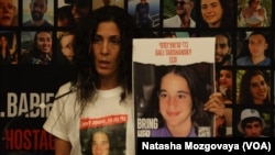 Reuma Arosi Tarschansky speaks holding a photo of her 13 year old daughter Gali abducted by Hamas to Gaza on Oct. 7, at a press conference in Tel Aviv, Nov. 14, 2023. 