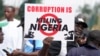 A man holds a banner during a protest against economic hardship, in Lagos, Nigeria, Aug 2, 2024.