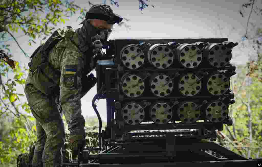 A Ukrainian soldier prepares a Croatian RAK-SA-12 128mm multiple rocket launcher to fire towards the Russian positions on the frontline near Bakhmut in the Donetsk region.