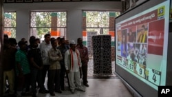 Supporters of India's main opposition party, Indian National Congress, monitor election results on television at their party office in Hyderabad, Telangana state, India, Dec.3, 2023. 