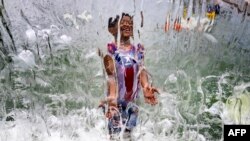 A young boy plays in the water fountain at Yards Park in Washington, D.C.