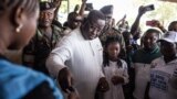 FILE: Incumbent President of Sierra Leone, Julius Maada Bio, casts his vote in Freetown on June 24, 2023 during the presidential vote.