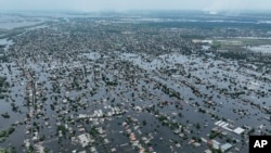 Houses are submerged in the town of Oleshky, Ukraine, June 10, 2023, from the breach of the Kakhovka Dam days earlier, on the Dnipro River in Ukraine. 