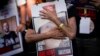 Relatives and friends of those kidnapped during the Oct. 7 Hamas cross-border attack in Israel hold photos of their loved ones during a protest calling for their return outside the Knesset, Israel's parliament in Jerusalem, Nov. 6, 2023.