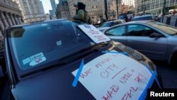 FILE - Drivers with the ride-sharing company Uber take part in a protest against a lawsuit which aims to block pay raises ordered by New York City Taxi and Limousine Commission in New York City, Dec. 19, 2022.