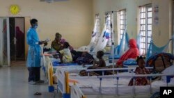 FILE - In this handout photo released by Doctors Without Borders, a physician checks on patients at the diphtheria treatment center of a hospital in Kano, Nigeria, Aug. 21, 2023.