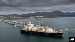 FILE - The tanker 'Sun Arrows' loads its cargo of liquefied natural gas from the Sakhalin-2 project in the port of Prigorodnoye, Russia, Oct. 29, 2021. 