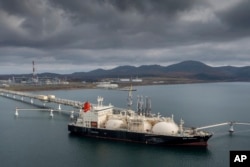 FILE - The tanker Sun Arrows loads its cargo of liquefied natural gas from the Sakhalin-2 project in the port of Prigorodnoye, Russia, Oct. 29, 2021. A new report says Russia sent significantly more oil and coal to India and China over the summer compared with the start of the year.