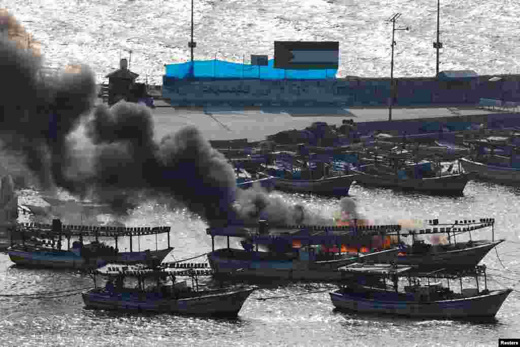 Smoke billows from a boat following Israeli strikes at the seaport of Gaza City, Oct. 8, 2023. 