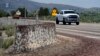 Mormon crickets make their way over a Jersey barrier during the migration of Mormon crickets, June 17, 2023, in Spring Creek, Nevada.