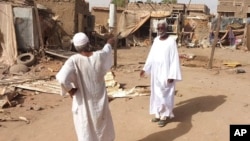 People check the rubble of their destroyed home after strikes at the Allamat district in Khartoum, Sudan, June 1, 2023.