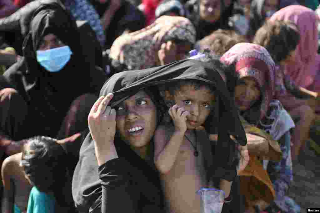 Rohingya Muslim woman reacts as she rests on a beach following her arrival in Blang Raya, Pidie, Aceh province, Indonesia.