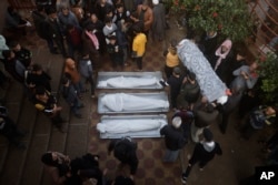 Palestinians attend a funeral of their relatives killed in the Israeli bombardment of the Gaza Strip in Khan Younis, Dec. 6, 2023.