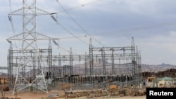 FILE - Power lines connecting pylons of high-tension electricity are seen from a power substation in Marsabit county, northern Kenya, Sept. 4, 2018. A nationwide power blackout hit Kenya Dec. 10 in the evening hours.