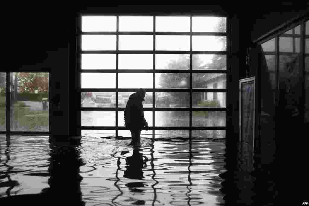 A garage owner walks in his flooded garage in Longfosse, northern France.