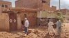 People check a damaged house in southern Khartoum, June 12, 2023, as deadly shelling and gunfire resumed after the end of a 24-hour cease-fire in Sudan.