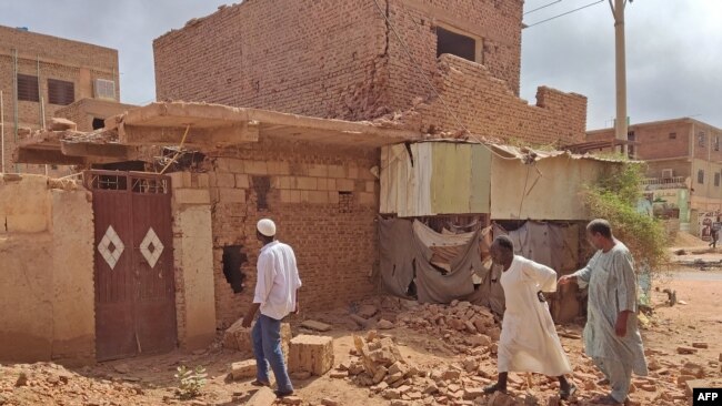 FILE - People check a damaged house in southern Khartoum on June 12, 2023 as deadly shelling and gunfire resumed after the end of a 24-hour ceasefire in Sudan.