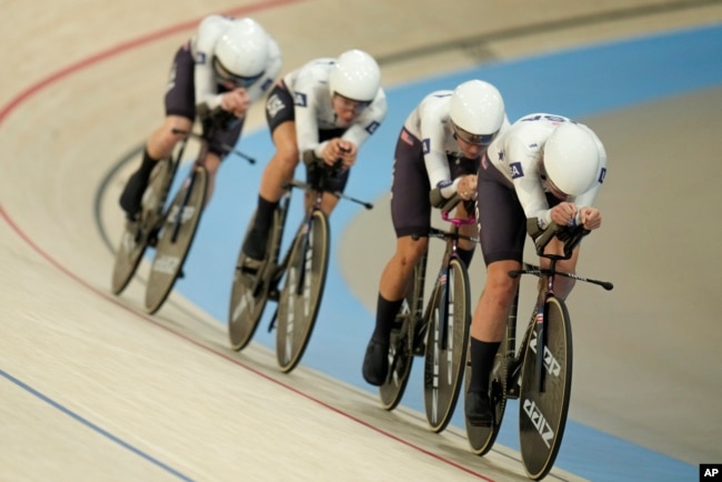 The United States' Jennifer Valente, Lilly Williams, Chloe Dygert and Kristen Faulkner compete on their way to clinch the gold medal in the women's team pursuit event, at the Summer Olympics, Aug. 7, 2024, in Paris.