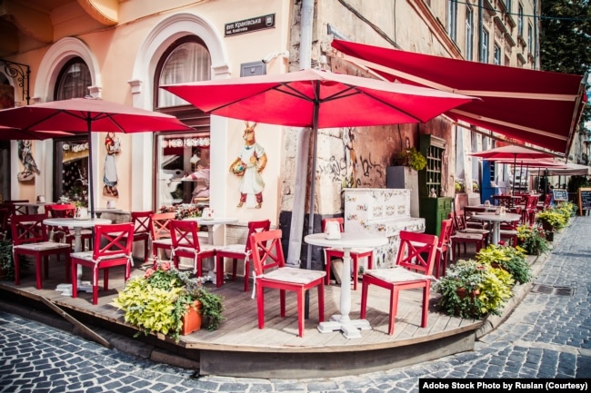 FILE - Lviv outdoor cafe with red umbrellas. (Adobe Stock Photo by Ruslan)