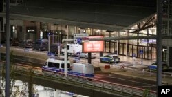 Police vehicles block access to Hamburg Airport during an operation, Nov. 4, 2023, in Hamburg, Germany. 