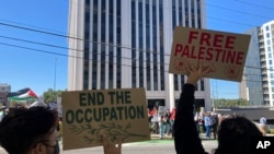 FILE - Pro-Palestinian demonstrators chant slogans outside the Israeli Consulate in Atlanta, Oct. 8, 2023. A protester with a Palestinian flag self-immolated outside the building on Dec. 1, 2023, authorities said. 