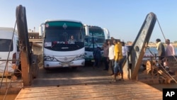 FILE: Buses carrying Sudanese, who fled the fighting in Sudan's capital, are leaving a ferry that transported to Egypt's southern city of Abu Simbel, May 7, 2023.