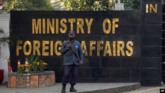 A police officer stands guard at the main entry gate of Pakistan's Ministry of Foreign Affairs, in Islamabad, Pakistan, Jan. 18, 2024.