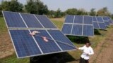 FILE - Farmer Pravinbhai Parmar cleans a solar panel installed at a farm in Dhundi village of Kheda district in western Indian Gujarat state, India, Jan. 13, 2023. 