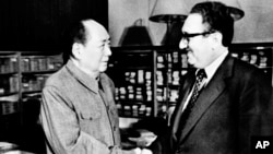 FILE - Chairman Mao Zedong, left, shakes hands with then U.S.
Secretary of State Henry Kissinger in Beijing, Nov. 12, 1973. Official China called Kissinger "an old friend."