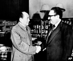 FILE - Chairman Mao Zedong shakes hands with then United States Secretary of State Henry Kissinger in Beijing, Nov. 12, 1973. Official China called Kissinger “an old friend.”