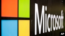 FILE - Microsoft logo is displayed at their offices in Sydney, Australia, Feb. 3, 2021. Microsoft says the early June 2023 disruptions to its Microsoft’s flagship office suite were denial-of-service attacks by a shadowy new hacktivist group.