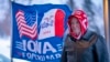 FILE - A man stands next to a flag that reading "Iowa for Trump" in Urbandale, Iowa, Jan. 11, 2024. Voters in the state are participating in caucuses on Jan. 15, 2024, that launch the Republican presidential nomination process.