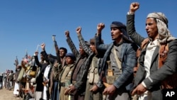 Houthi fighters and tribesmen stage a rally against the U.S. and the U.K. strikes on Houthi-run military sites near Sanaa, Yemen, Jan. 14, 2024. The U.S. military fired another wave of missiles at Houthi-controlled sites Jan. 17.