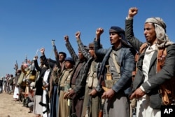 Houthi fighters and tribesmen stage a rally against the U.S. and the U.K. strikes on Houthi-run military sites near Sanaa, Yemen, Jan. 14, 2024.
