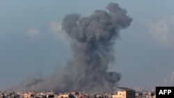 FILE - Smoke billows after Israeli bombardment on Khan Yunis as seen from Rafah, in the southern Gaza Strip on March 9, 2024, amid ongoing battles between Israel and the Palestinian militant group Hamas.